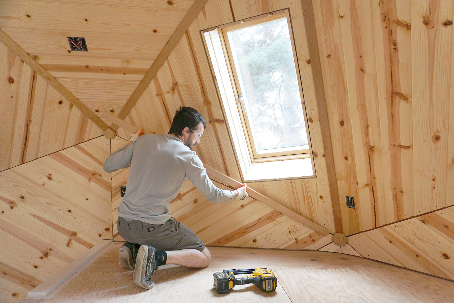 The panel trim being installed in the mini dome.