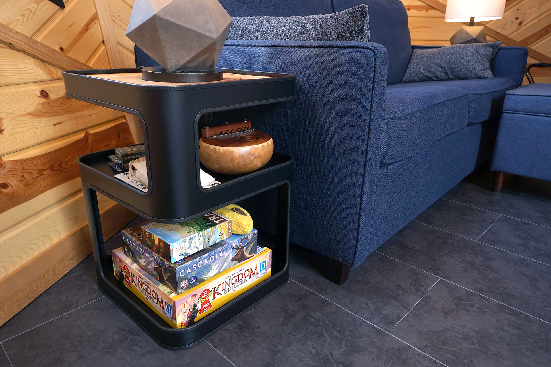 A detailed shot of the side table, featuring a small collection of board games and a thumb piano musical instrument.