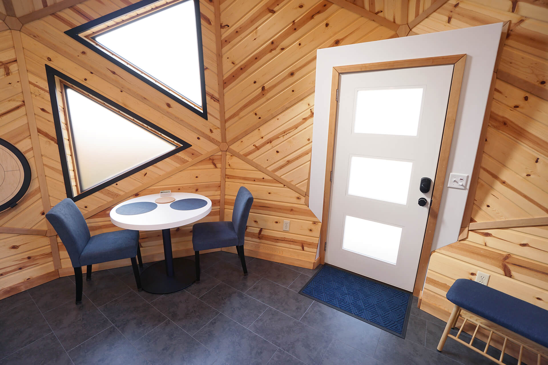 View of the dining room area and entrance, highlighting the open layout and design.