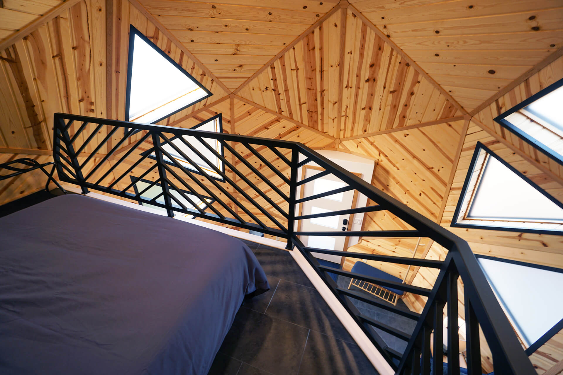 Close-up of the custom loft railing, designed to reflect the triangular shapes of the surrounding walls.