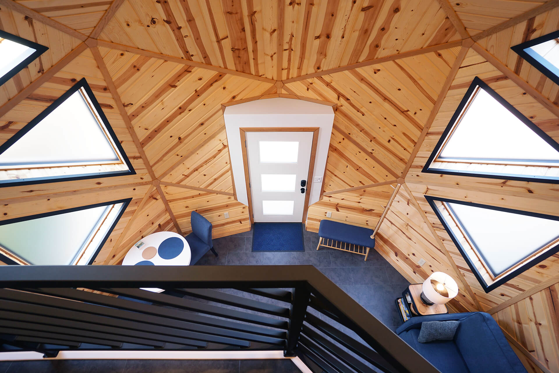 View from the loft railing, overlooking the open floor plan of the living space below.