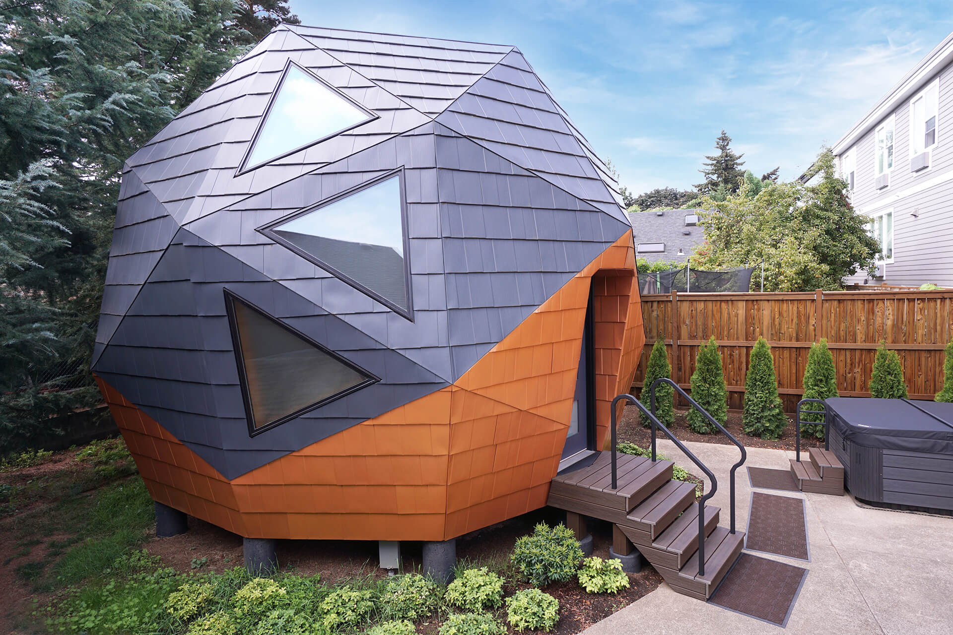 Side view of the mini geodesic dome home as viewed from the porch of the primary house.